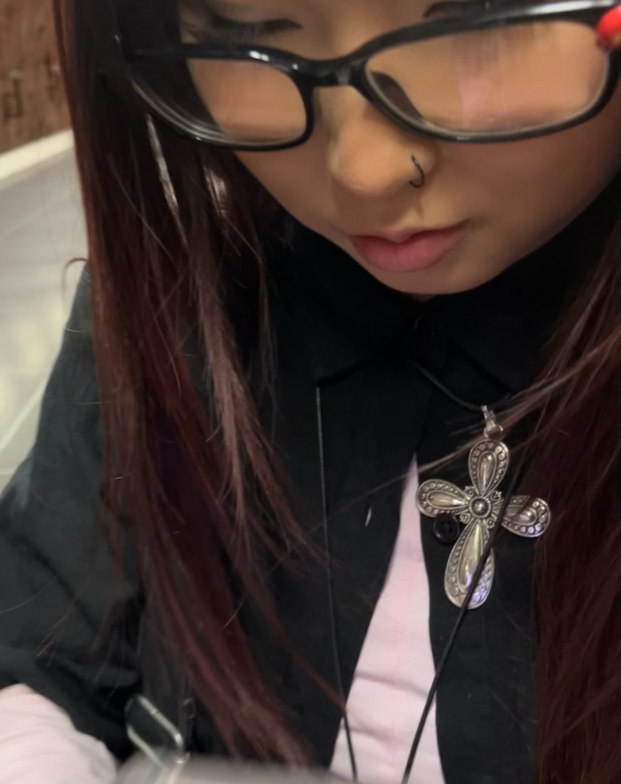 Ariuka, pictured in alternative clothing, wearing a cross. Pihla Saxell